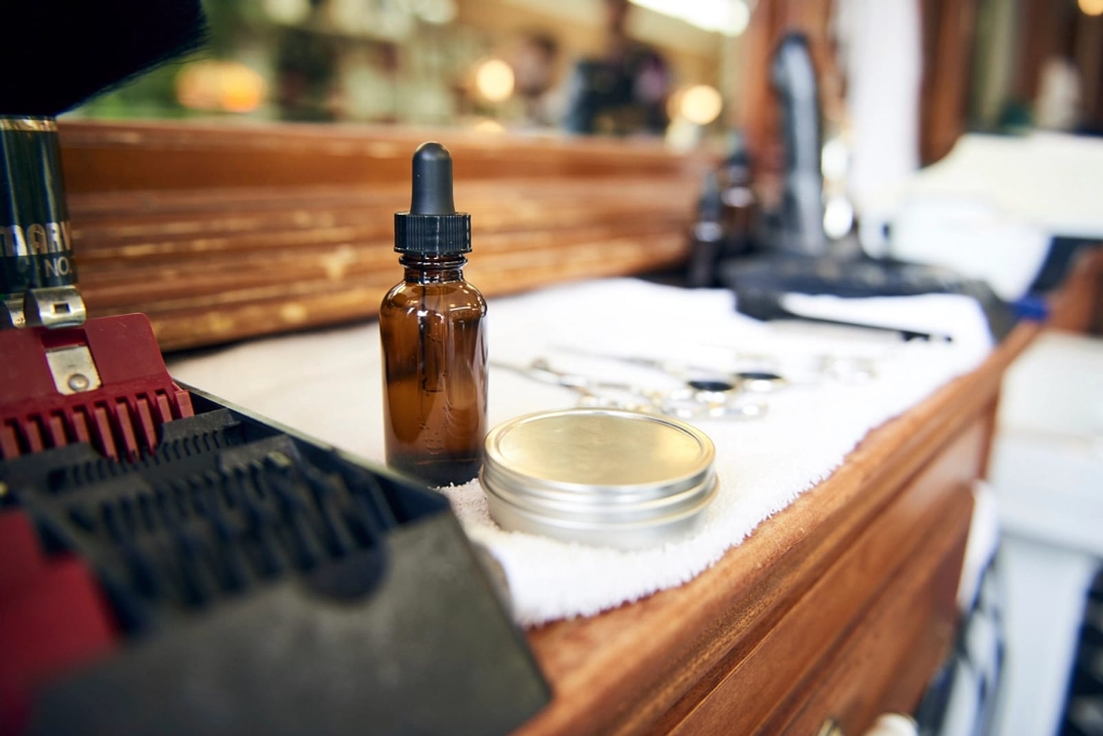 Combs, shears and styling products laid out on a salon station